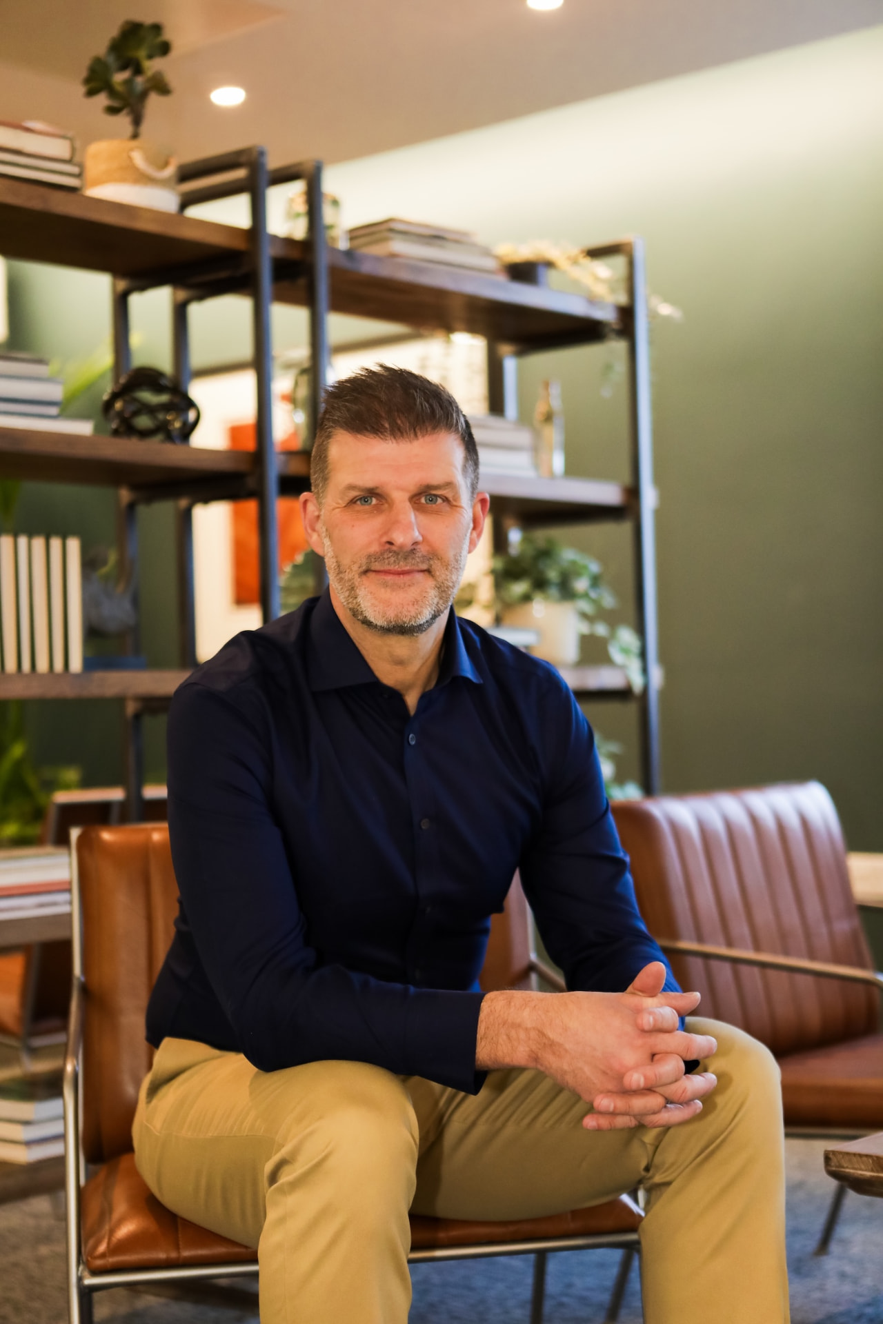 Neil Heyes, founder of We Forge Growth, seated in a studio office